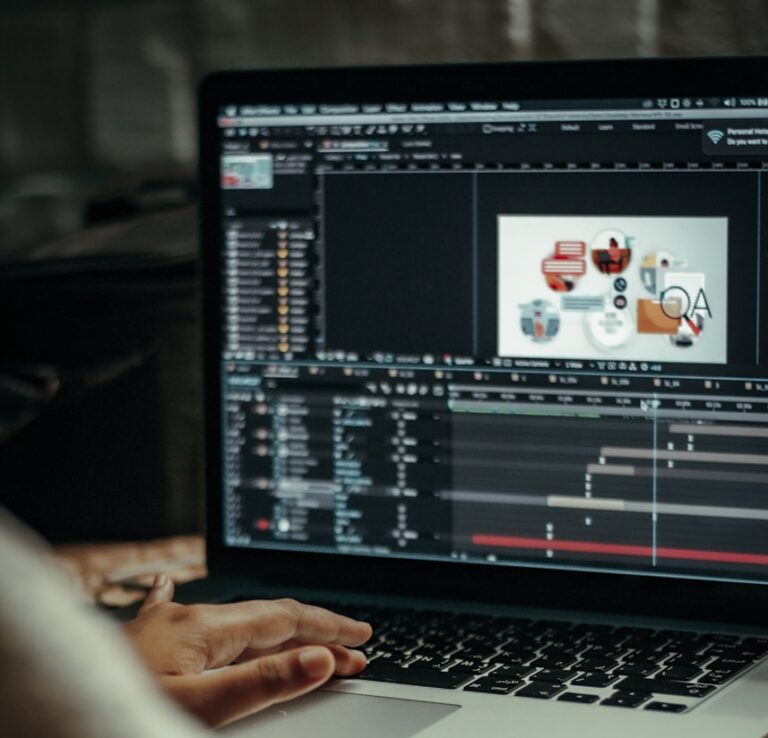 person using macbook pro on table